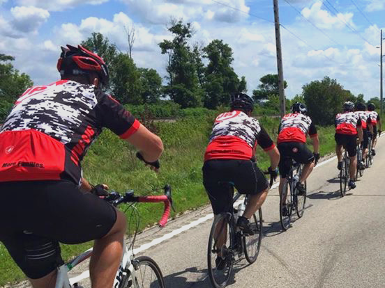 The pack sporting their red Man Up and Go jerseys as they ride en route to Cedar Falls.