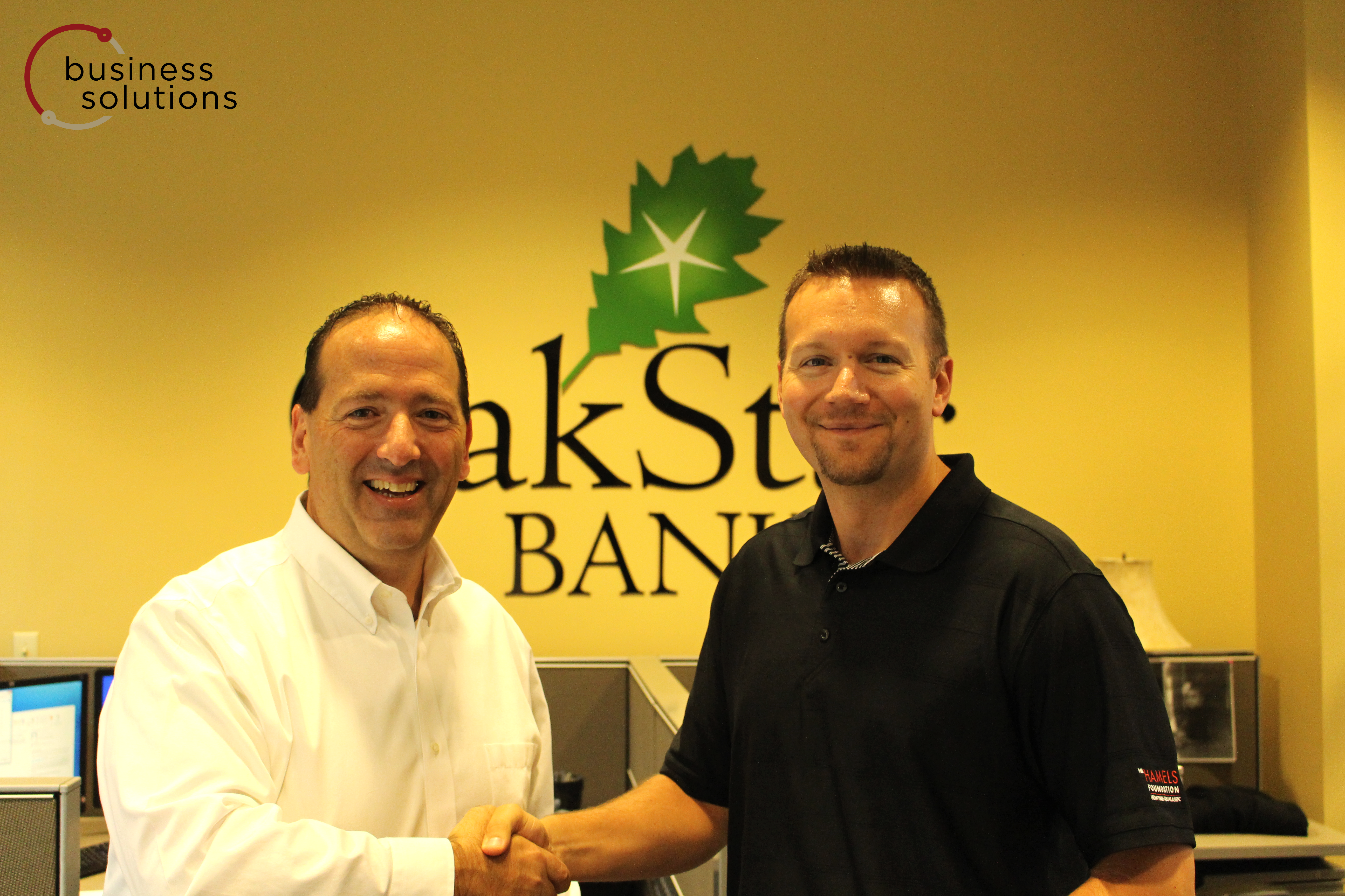 McFail poses with Business Solutions executive  Mike Lofaro after receiving his prize.